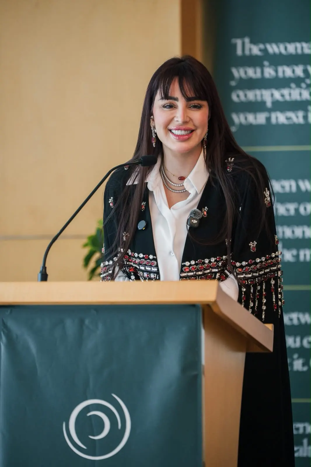 A speaker smiling at the Era Of You podium.